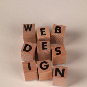 Wooden blocks arranged to spell 'Web Design'. Perfect for creative, digital content themes.